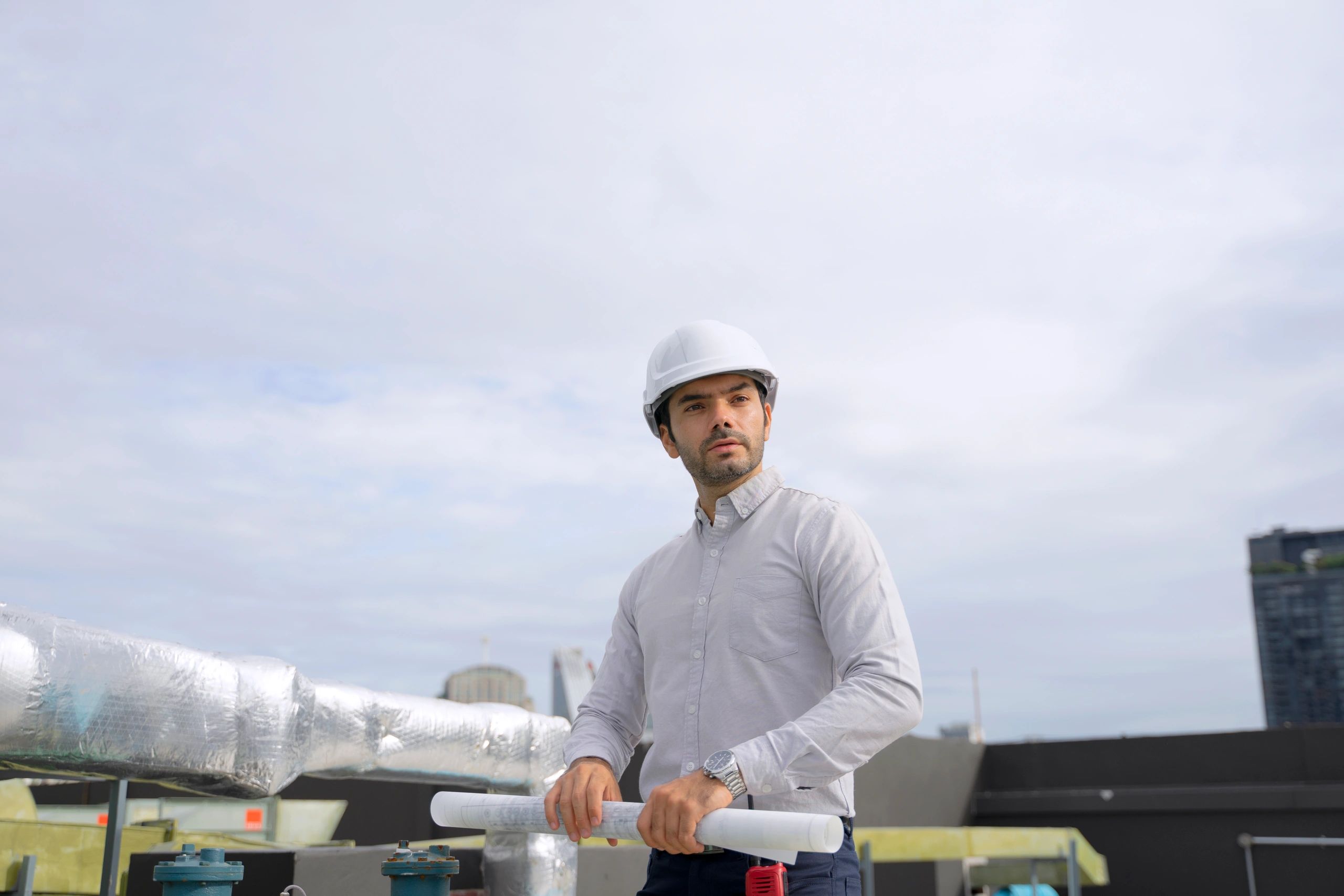 Technician working on a commercial rooftop HVAC unit