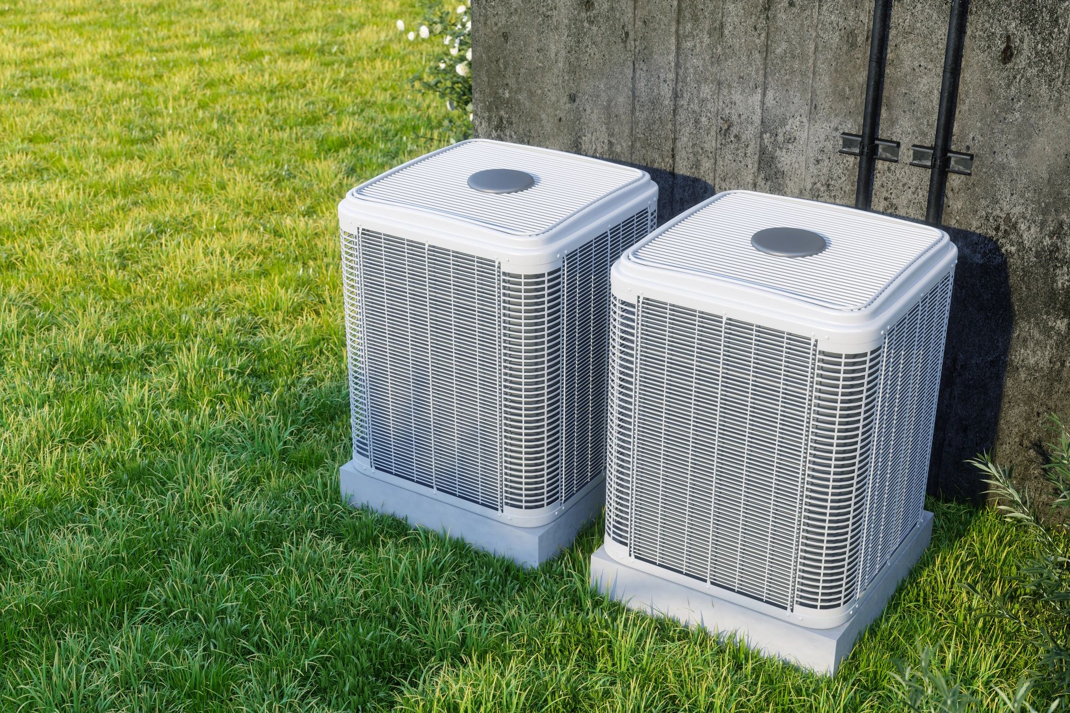 Outdoor air conditioning condenser units installed beside a home